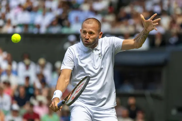 Dan Evans in action a Wimbledon