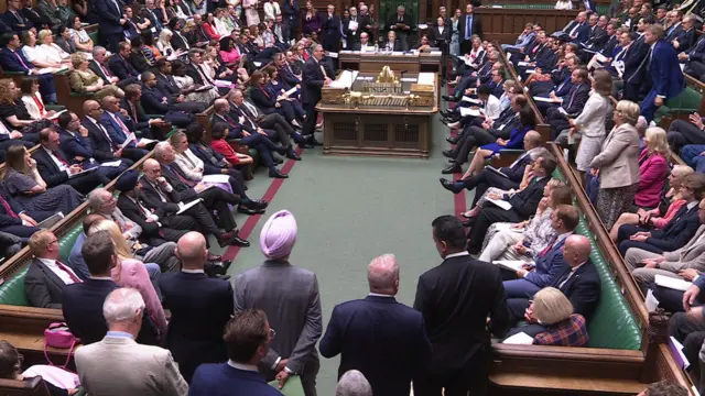 Keir Starmer stands in the House of Commons. The room is full of MPs during a Prime Minister's Questions session.