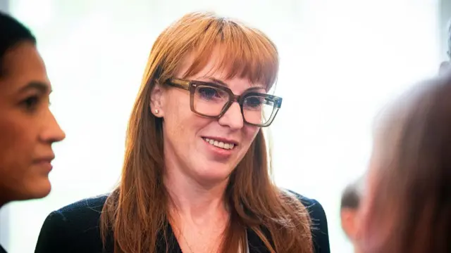 Angela rayner speaking to two people during a reception