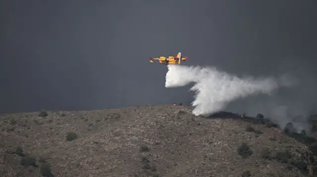 A picture taken on July 10, 2026 shows a Canadair water bombing aircraft on the site on a wildfire that killed 11 near Los Gallardos, in Almeria Province