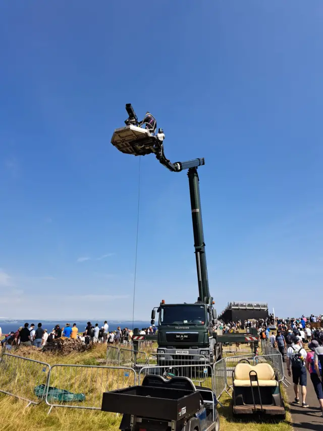 Camera man on top of a crane