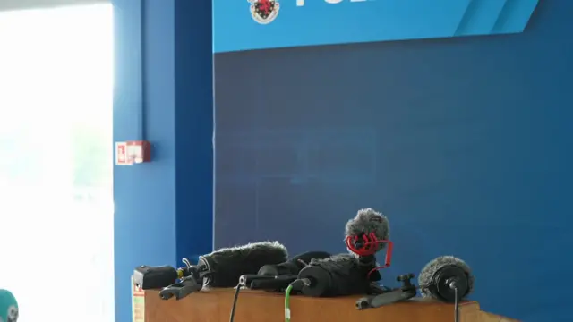 Microphones on a stand in front of blue background