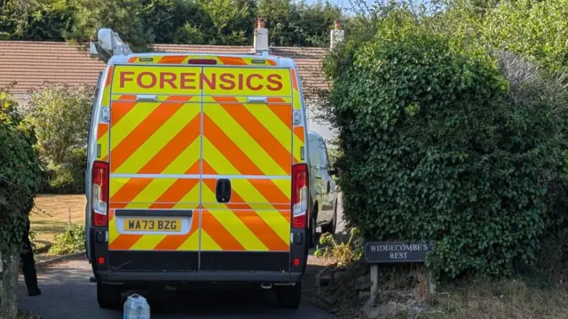 A forensics van parked in a driveway