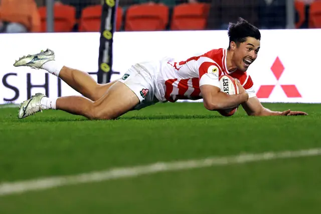 Japan celebrate scoring a try