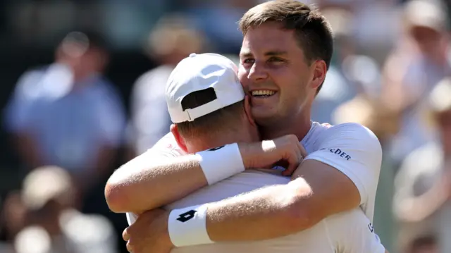 Henry Patten and Harri Heliovaara hug after their win