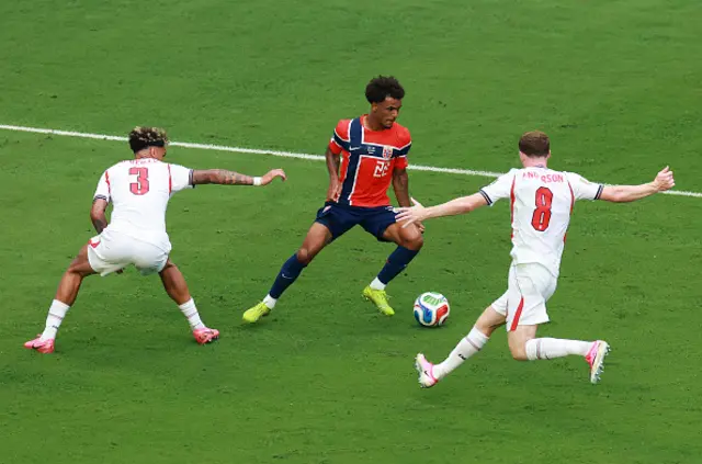 Oscar Bobb #22 of Norway controls the ball against Nico O'Reilly #3 and Elliot Anderson