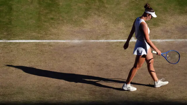 Linda Noskova walks at the back of the court