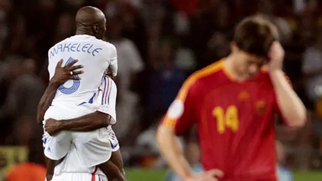 France players celebrate as a Spain players hangs his head after their 2006 World Cup tie