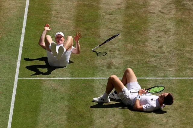 Henry Patten and Harri Heliovaara celebrate their victory by falling to the floor