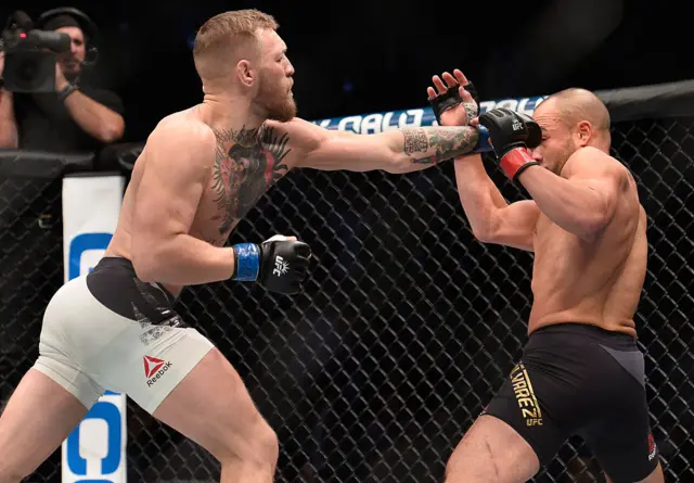 Conor McGregor and Eddie Alvarez in the octagon