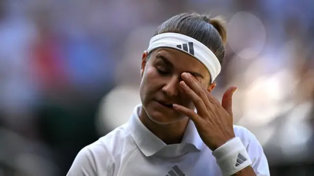 Karolina Muchova scratches her eye