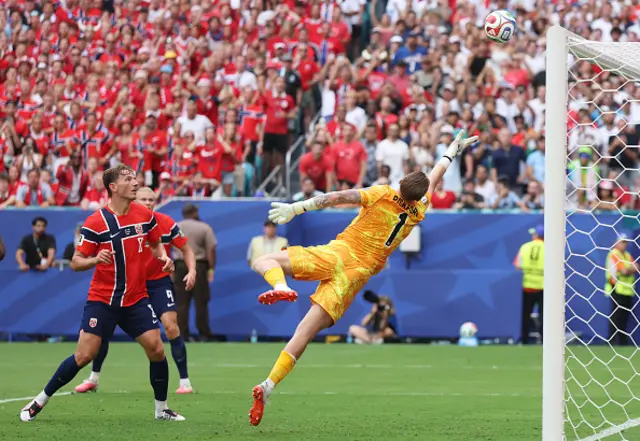 Jordan Pickford #1 of England dives as the header by Kristoffer Ajer