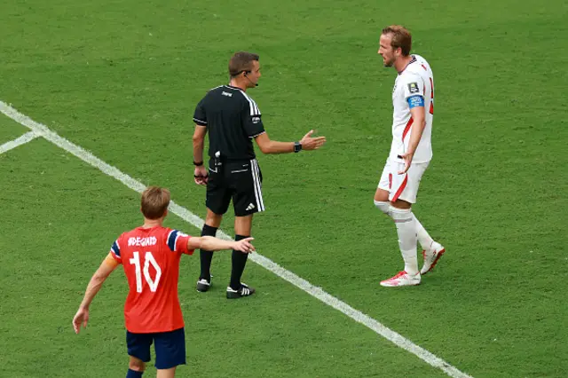 : Harry Kane #9 of England speaks with referee Clement Turpin