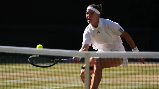 Karolina Muchova hits a forehand at the net