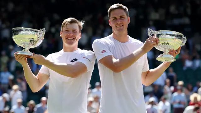 Harri Heliovaara and Henry Patten hold their Wimbledon trophies