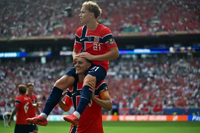 Andreas Schjelderup celebrates scoring his team's first goal on the shoulders of midfielder #10 Martin Odegaard