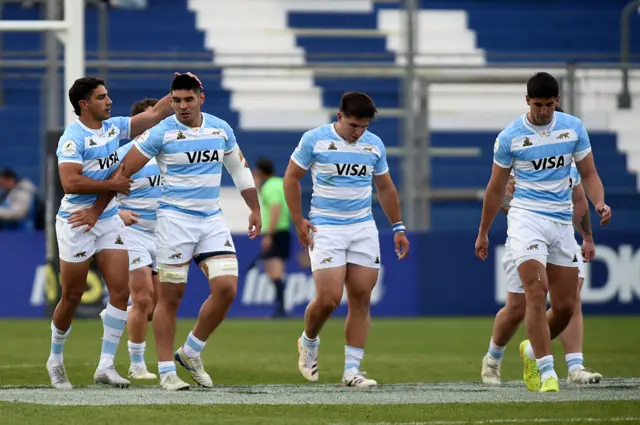 Joaquin Oviedo (2nd L) celebrates with teammates after scoring a try