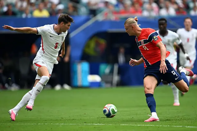 John Stones and Norway's forward #09 Erling Braut Haaland fight for the ball