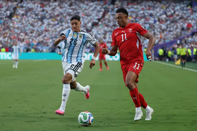 Nahuel Molina and Dan Ndoye fight for the ball