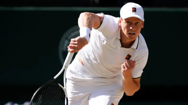 Jannik Sinner serves