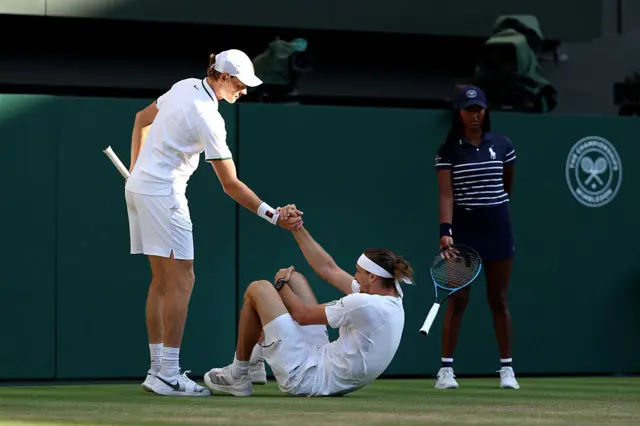 Jannik Sinner helps Alexander Zverev off the floor