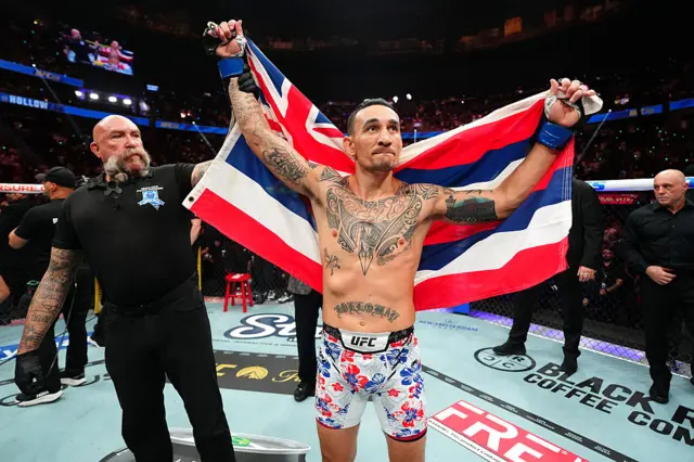 Max Holloway holding the Hawaii flag