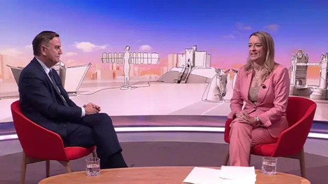 Mel Stride and Laura Kuenssberg pictured on the set of the show, sitting in red chairs.