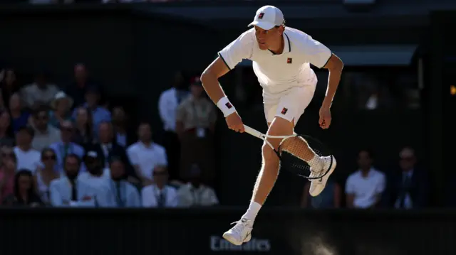 Jannik Sinner serves