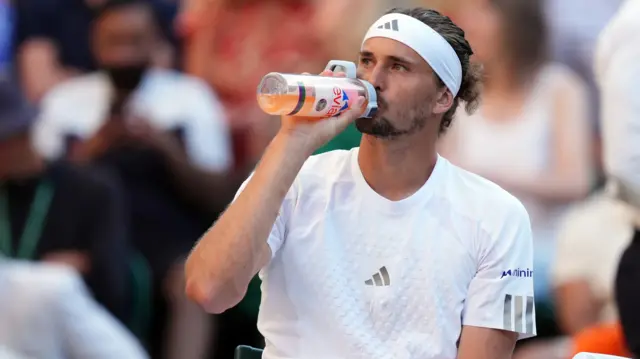 Alexander Zverev drinks from his water bottle