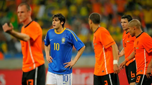 Kaka of Brazil is watched by the Netherlands defence