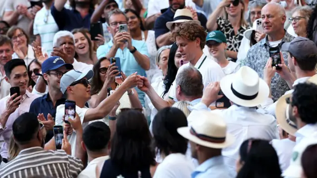 Jannik Sinner walks through the crowd
