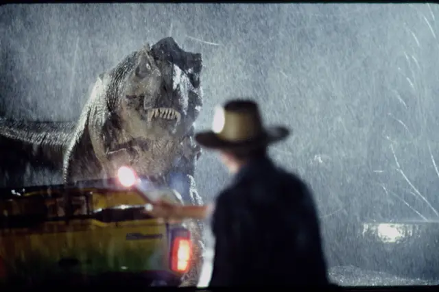 Actor Sam Neill as Dr. Alan Grant takes on a Tyrannosaurus Rex in a scene from the film 'Jurassic Park', 1993