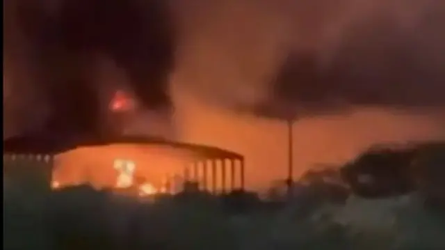 A still image from a verified video showing a fire in a hangar at Aghajari Airport in Omidiyeh, south-western Iran