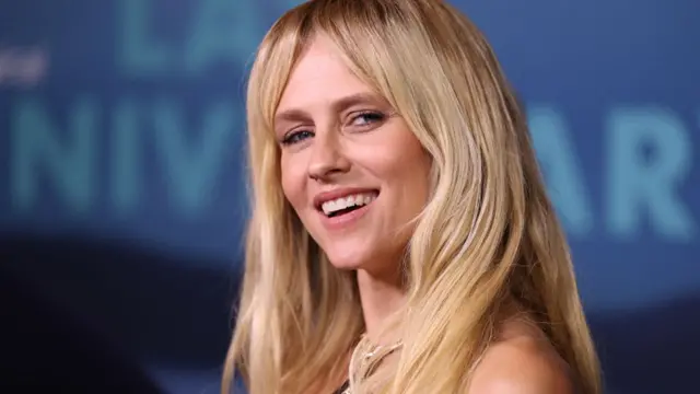 Teresa Palmer with long blonde hair, smiling at the camera