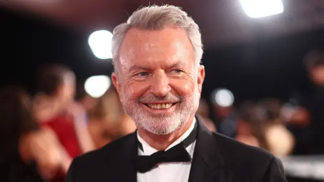 Sam Neill in a black bow tie and dinner jacket