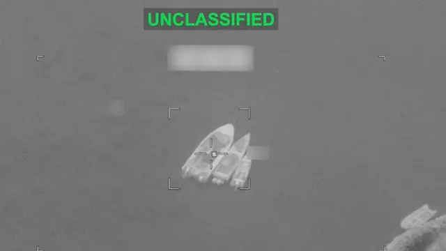 Three small boats on the water, image is black and white. Image has a small white box around the boats and the word classified is at the top of the image in green.