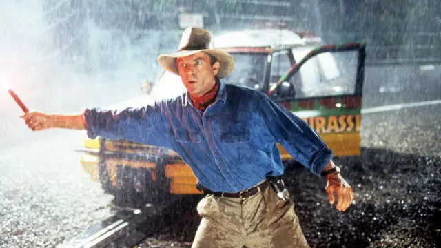 Sam Neill stands out in the rain in a scene from the film 'Jurassic Park', 1993