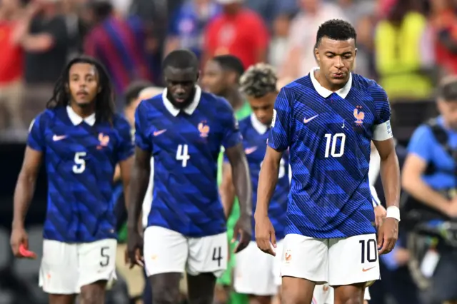 Kylian Mbappe of France (R) and teammates show disappointment