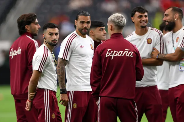 Spain players inspect pitch