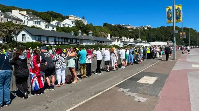 Crowds wait to watch the King on the horse tram
