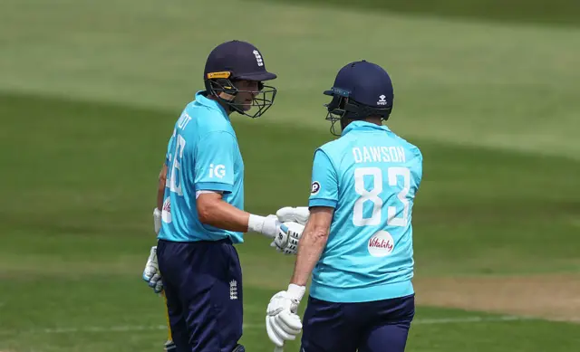 Joe Root and Liam Dawson punch gloves