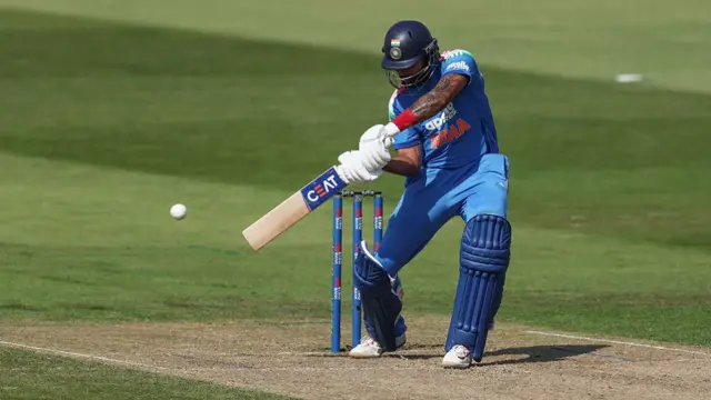 Shreyas Iyer, wearing all blue and a dark blue helmet, plays a shot