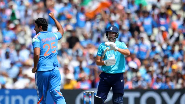 Shivam Dube (left, running away from the camera and wearing all blue) wheels away in celebration with his right arm in the air, with Will Jacks, wearing pale blue shirt, dark blue trousers and helmet standing with his bat tucked under his arm