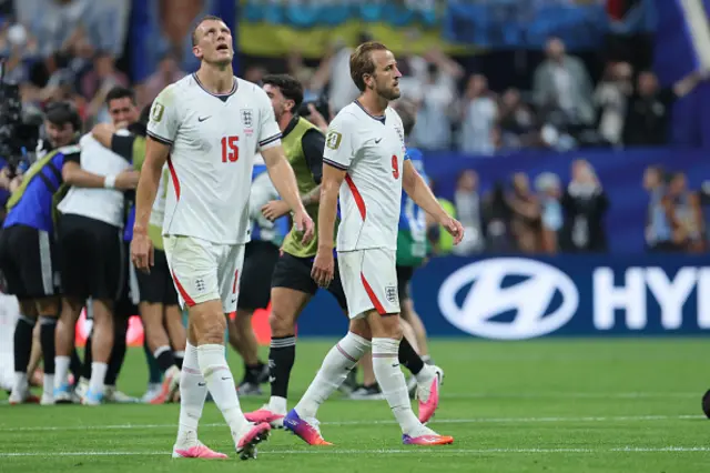 Dan Burn (L) and Harry Kane of England look dejected