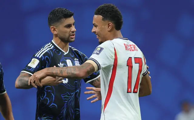 Cristian Romero of Argentina and Morgan Rogers of England tussle