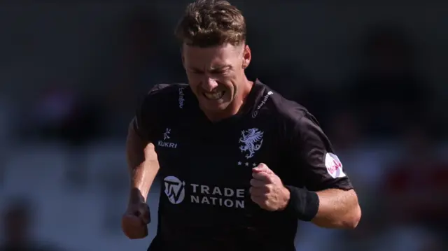 Riley Meredith celebrates taking a wicket