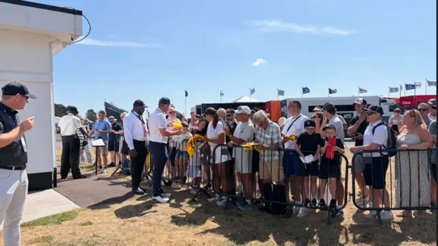 Bryson Dechambeau signs autographs for fans