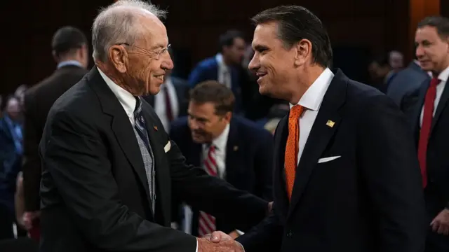 Chuck Grassley shakes hands with Todd Blanche