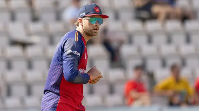 Noah Thain moments after taking a catch for Essex
