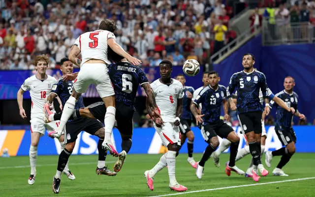 Stones wins a header at the back post